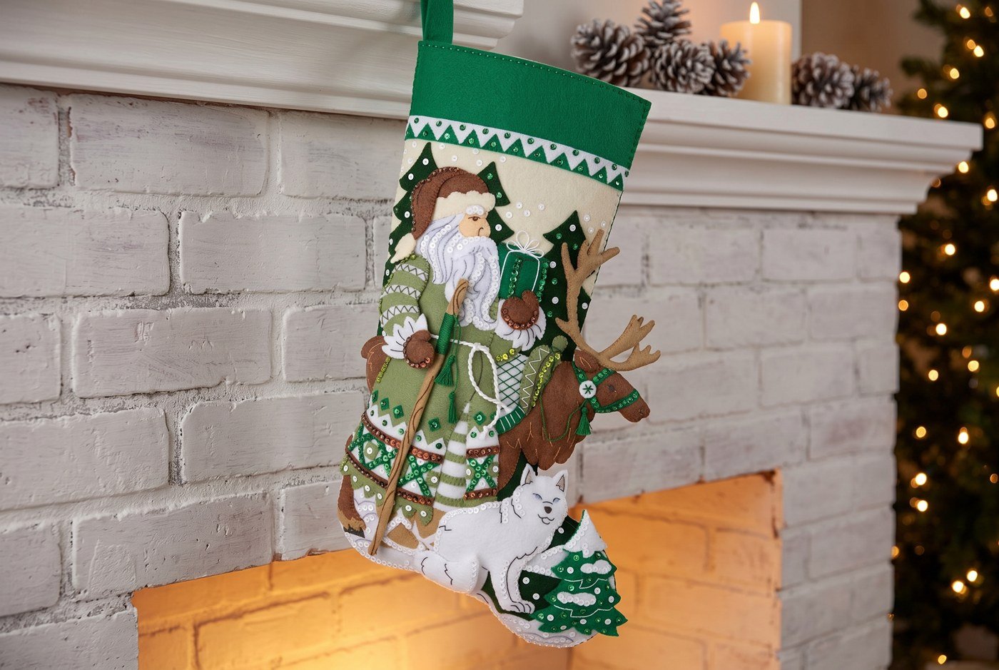 Bucilla Nordic Noel felt-applique stocking 89758E — sage green and cream base with Father Christmas in a Fair Isle coat, reindeer with antler tassels, and white arctic fox curled at his feet